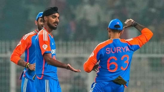 India's Arshdeep Singh, center, celebrates with captain Suryakumar Yadav, right, and Axar Patel after taking the wicket of England's Ben Duckett