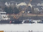 Searchers can be seen sifting through the debris of a fatal midair accident between the airline and an Army helicopter in the Potomac River. (AP Photo/Alex Brandon)