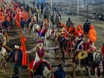 Naga Sadhus led most of the akharas during the sacred bathing ritual on Basant Panchami, displaying their weapon-handling skills by wielding spears, swords and tridents with precision. Some Naga sadhus were seen riding horses, while others walked barefoot with garlands draped around their necks and tridents held high.(Deepak Gupta/Hindustan Times)